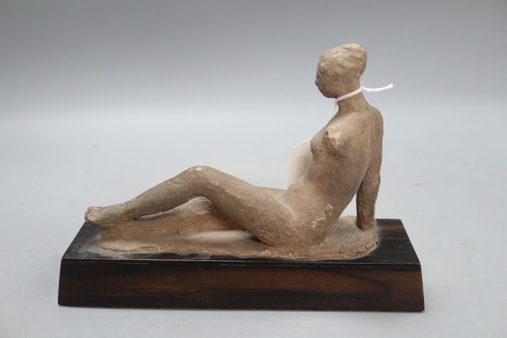 A terracotta maquette of a reclining nude, on coromandel plinth, height 17cm width 23cm